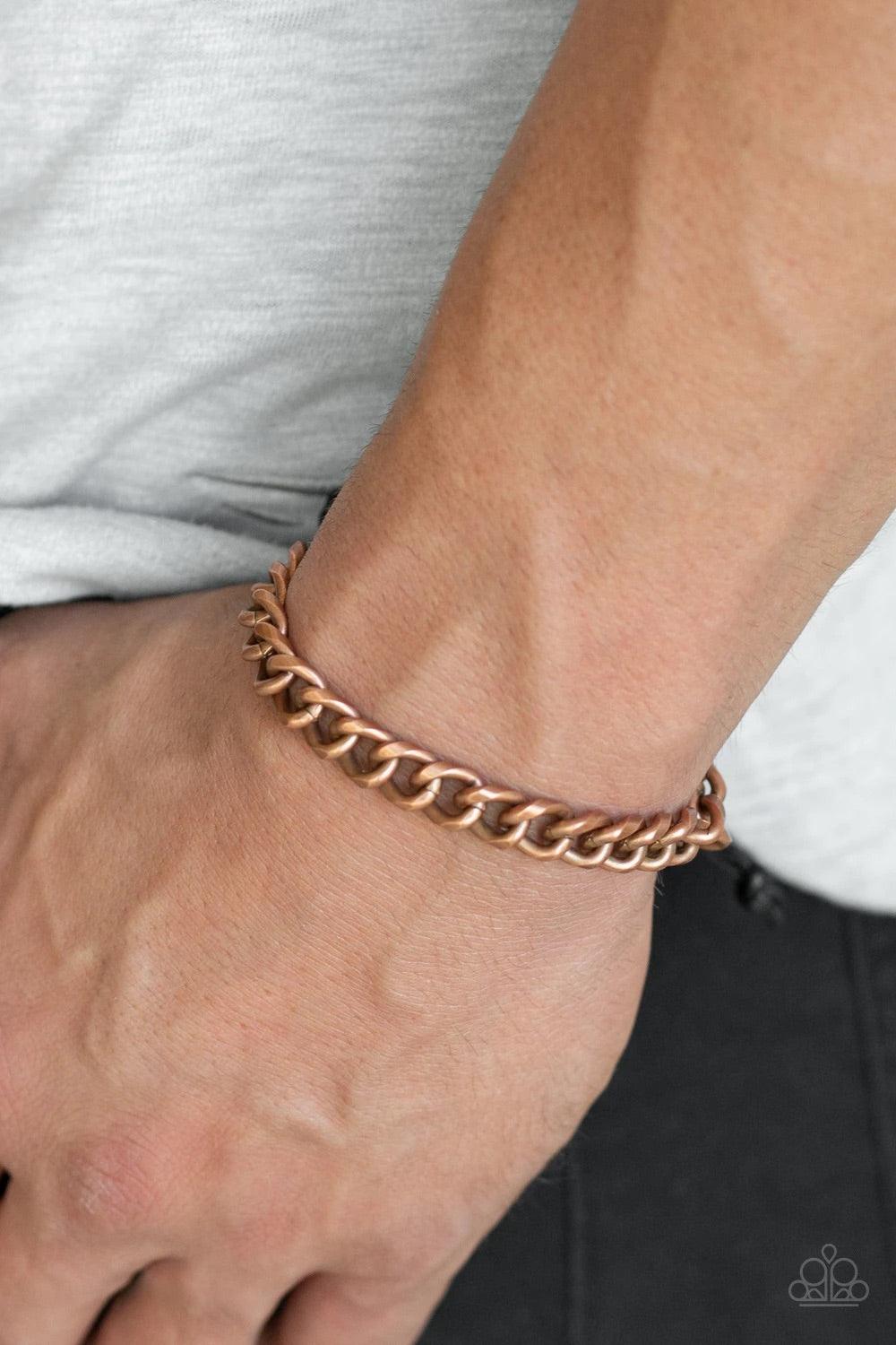 Paparazzi Accessories Blitz - Copper Shiny black cording knots around the ends of a copper beveled cable chain that is wrapped across the top of the wrist for a versatile look. Features an adjustable sliding knot closure. Jewelry