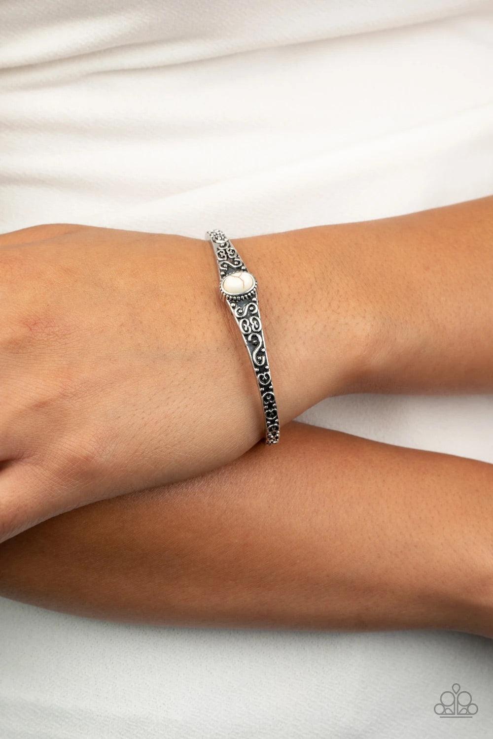 Paparazzi Accessories Make Your Own Path - White Infused with a refreshing white stone center, a dainty silver cuff has been embossed in swirling antiqued detail for a seasonal look. Sold as one individual bracelet. Jewelry