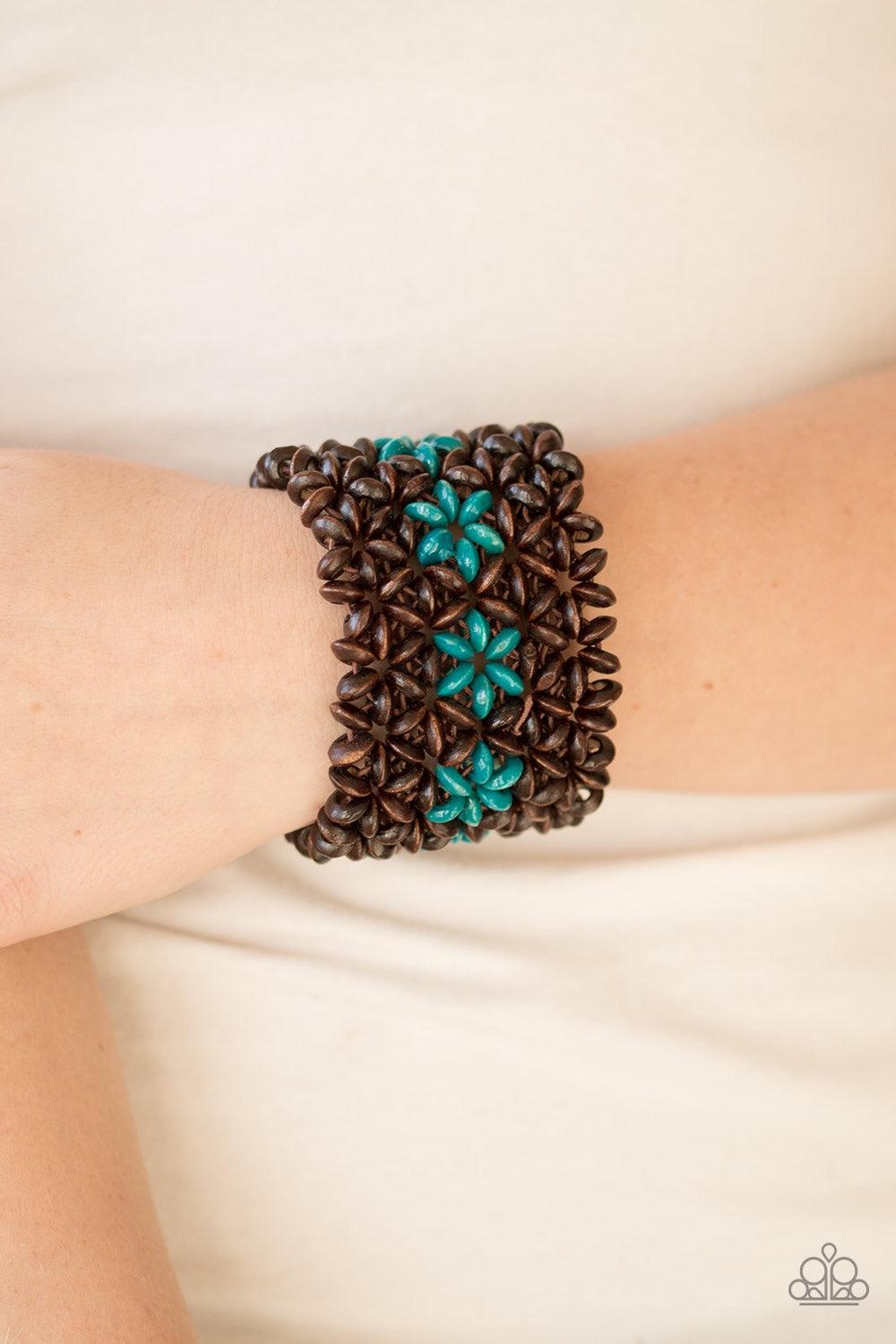 Paparazzi Accessories Bahama Babe - Blue Earthy wooden accents are threaded along elastic stretchy bands, creating an ornate bracelet. Tinted in a refreshing finish, blue wooden beads gather down the center, creating summery floral accents for a colorful