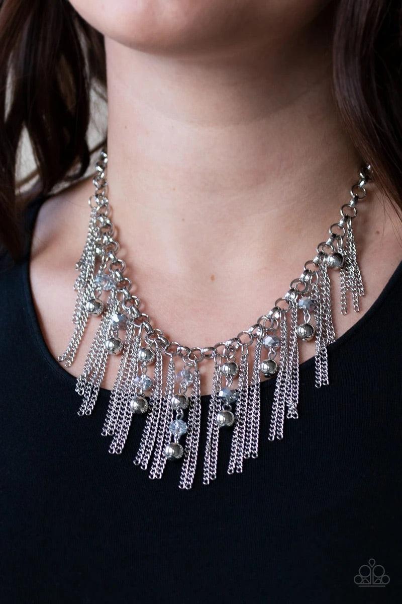 Paparazzi Accessories Ever Rebellious - Silver Glistening silver chains and strands of metallic crystal-like beads and glistening silver beads stream from the bottom of a bold silver chain, creating a sassy fringe below the collar. Features an adjustable