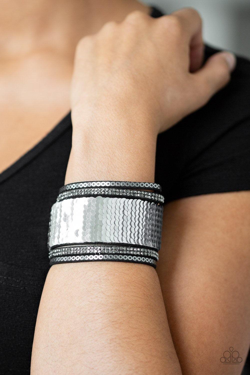 Paparazzi Accessories Heads Or Mermaid Tails - Silver nfused with strands of smoky hematite rhinestones and dainty metallic accents, row after row of shimmery sequins are stitched across the front of a spliced black suede band. Bracelet features reversibl