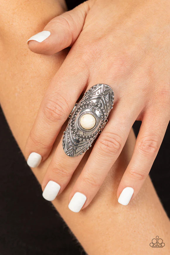 Paparazzi Accessories Rural Residence - White An earthy white stone creates a colorful centerpiece for an oversized elongated silver frame. Embellished with studded texture and geometric designs, the patterned frame results in a hypnotizing lure atop the
