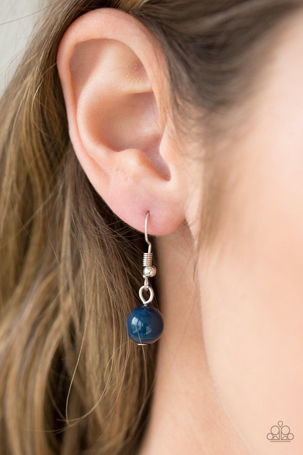 Paparazzi Accessories Carefree and Capricious - Blue Polished blue and faceted silver beads trickle along shimmery silver hoops for an asymmetrical look. The colorful beading gives way to layers of shimmery silver chain for a seasonal finish. Features an