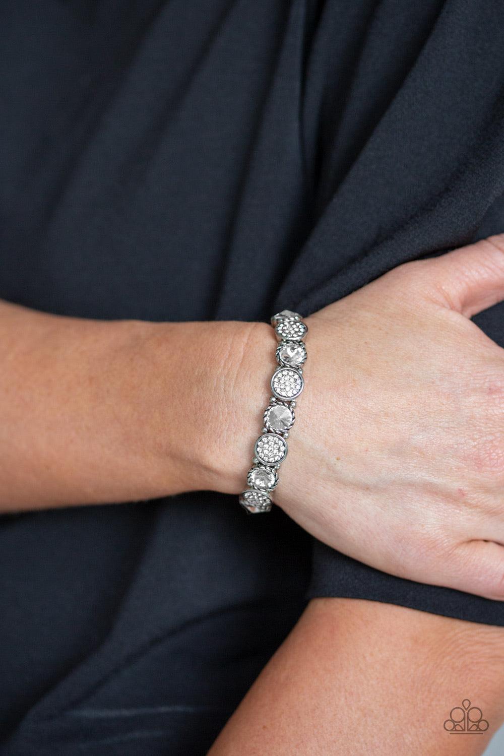 Paparazzi Accessories Take A Moment To Reflect - White Featuring an array of glittery white rhinestones, mismatched silver frames and dainty silver beads are threaded along stretchy bands around the wrist for a glamorous flair. Jewelry