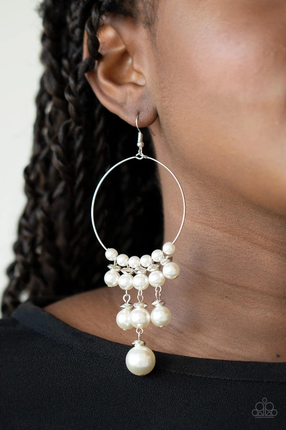Paparazzi Accessories Working The Room - White Tiers of faceted silver beads and bubbly white pearls dangle from the bottom of a dainty silver wire hoop, creating an elegant fringe. Earring attaches to a standard fishhook fitting. Sold as one pair of earr