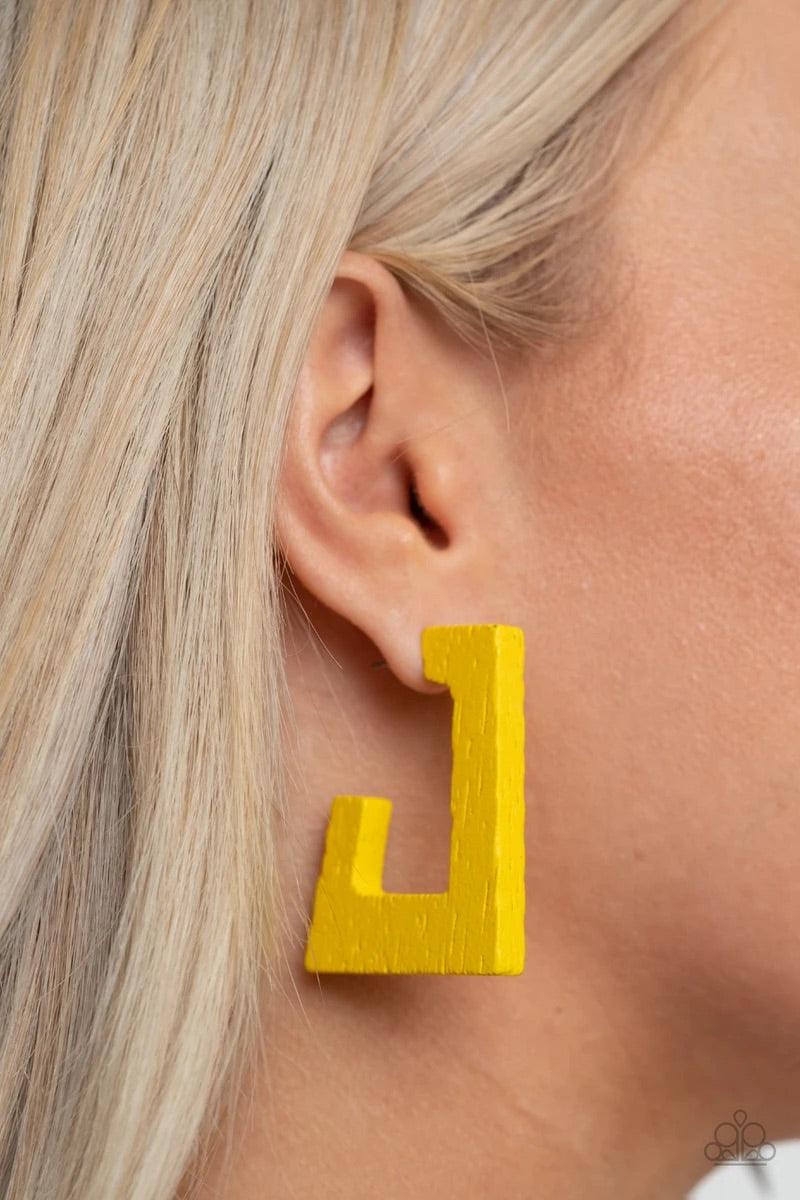 Paparazzi Accessories The Girl Next OUTDOOR - Yellow Painted in a sunny yellow finish, a distressed wooden frame curves around the ear, creating a rectangular hoop for a retro effect. Earring attaches to a standard post fitting. Hoop measures approximatel