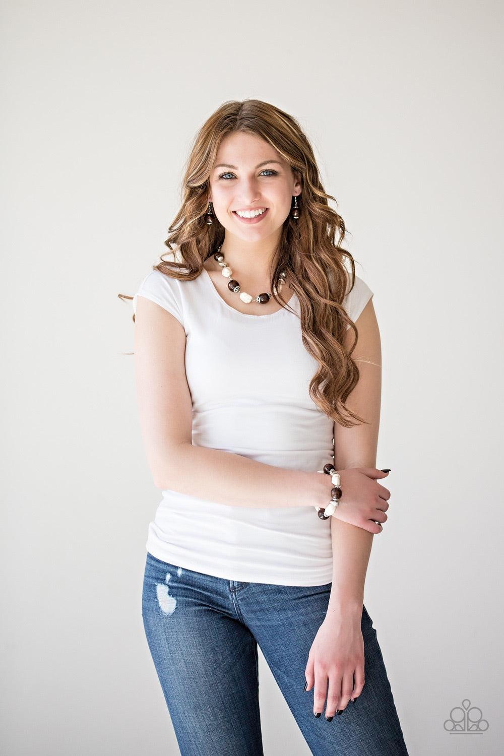 Paparazzi Accessories Earth Goddess - White Infused with ornate silver accents, refreshing white stones and round wooden beads trickle along a shimmering silver chain, creating an artisanal statement piece that falls just below the collar. Features an adj