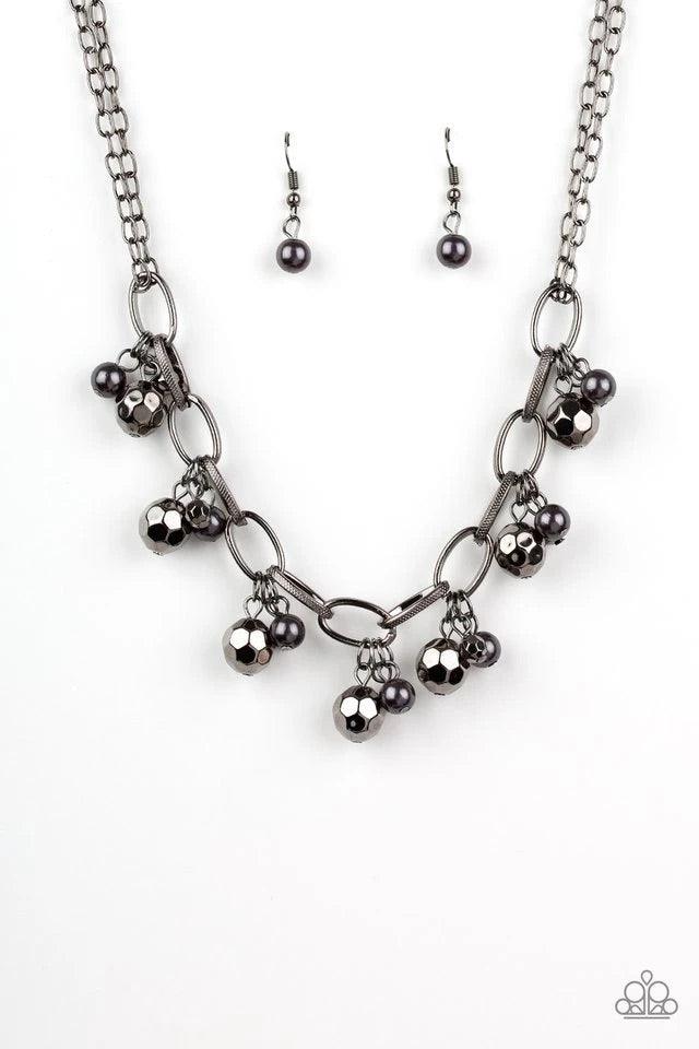 Paparazzi Accessories Malibu Movement - Black Varying in size, a collection of faceted gunmetal and pearly gunmetal beads swings from a bold gunmetal chain, creating a whimsical metallic fringe below the collar. Features an adjustable clasp closure. Jewel