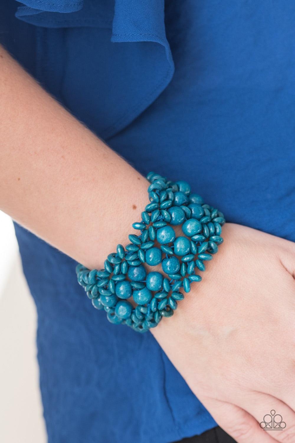 Paparazzi Accessories Tropical Bliss - Blue Blue wooden accents are threaded along elastic stretchy bands, creating an ornate bracelet. Rounded blue wooden beads line the center of the summery pattern for a bold finish. Jewelry