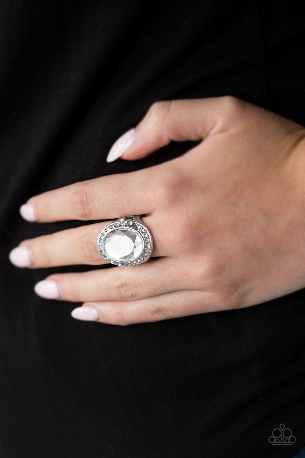 Paparazzi Accessories Queen Scene - White A dramatic white gem is pressed into a round silver frame radiating with glassy white rhinestones for a statement-making finish. Features a stretchy band for a flexible fit. Jewelry