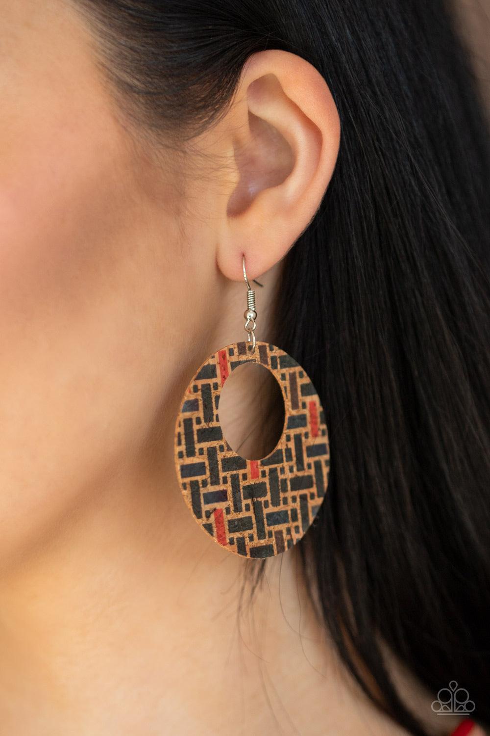 Paparazzi Accessories Put A Cork In It - Black Painted in a colorful geometric print, a cork-like hoop swings from the ear in a seasonal fashion. Earring attaches to a standard fishhook fitting. Jewelry