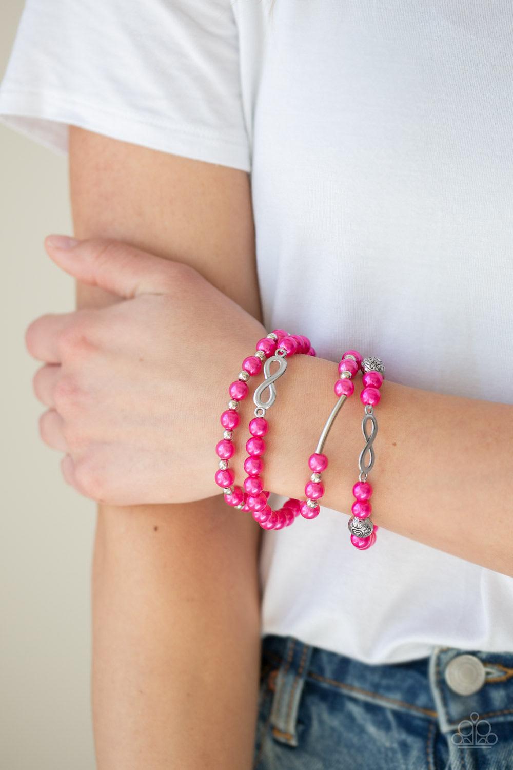 Paparazzi Accessories Limitless Luxury - Pink Infused with an array of silver accents, a collection of pink pearls and silver infinity charms are threaded along stretchy bands around the wrist for a glamorous look. Sold as one set of three bracelets. Jewe