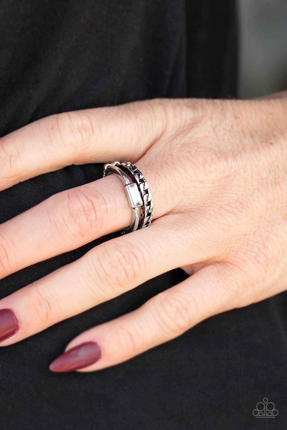 Paparazzi Accessories Edge Effect - Silver A smooth silver and chain-like band layer across the finger. Featuring an edgy emerald style cut, a glittery smoky rhinestone is pressed into the shiny silver band for a glittery finish. Features a dainty stretch