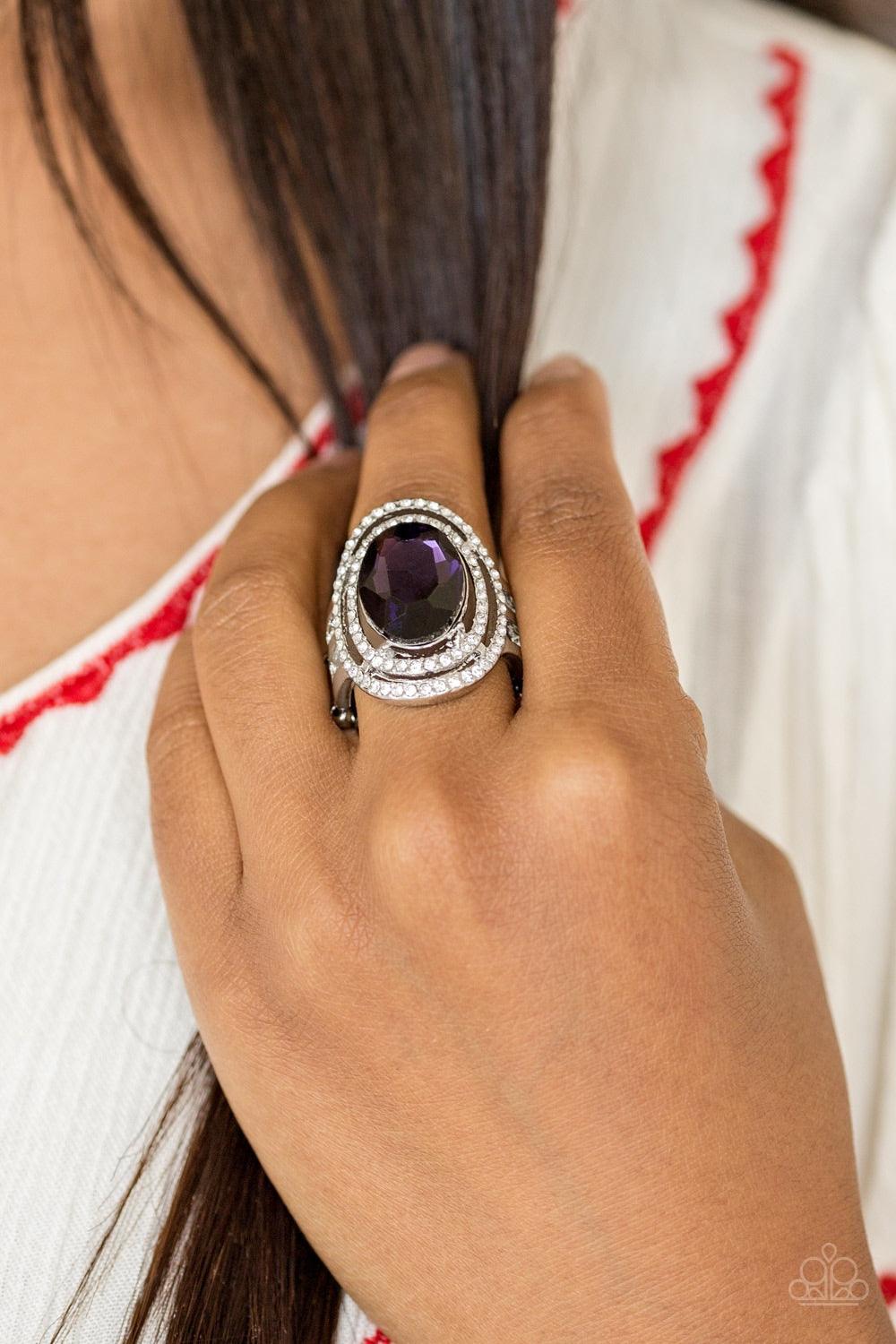 Paparazzi Accessories Making History - Purple A glittery purple gem sits atop stacked silver frames radiating with glassy white rhinestones for a timeless look. Features a stretchy band for a flexible fit. Jewelry