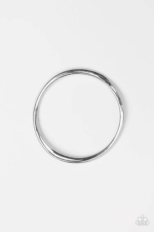 Paparazzi Accessories Awesomely Asymmetrical - Silver Featuring a warped surface, an asymmetrical shiny silver bangle slides along the wrist for an edgy look. Jewelry