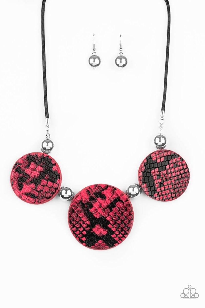 Paparazzi Accessories Viper Pit - Pink A wild collection of oversized silver beads and black and pink python patterned leather pieces are strung along an invisible wire below the collar for statement-making finish. Features an adjustable clasp closure. So