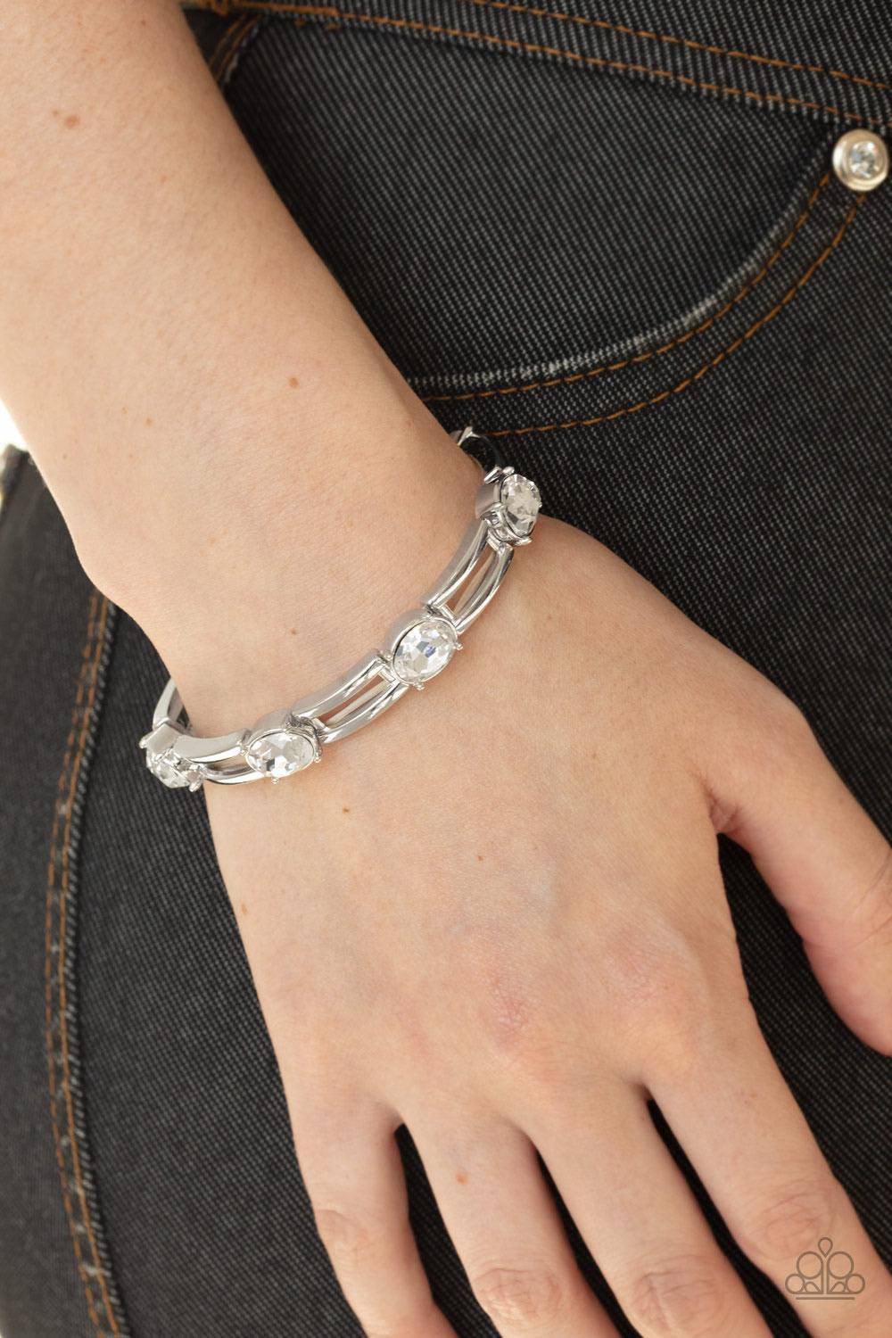 Paparazzi Accessories FLASH or Credit? - White A glittery collection of white rhinestones and airy rectangular silver frames are threaded along stretchy bands around the wrist for a glitzy look. Sold as one individual bracelet. Jewelry