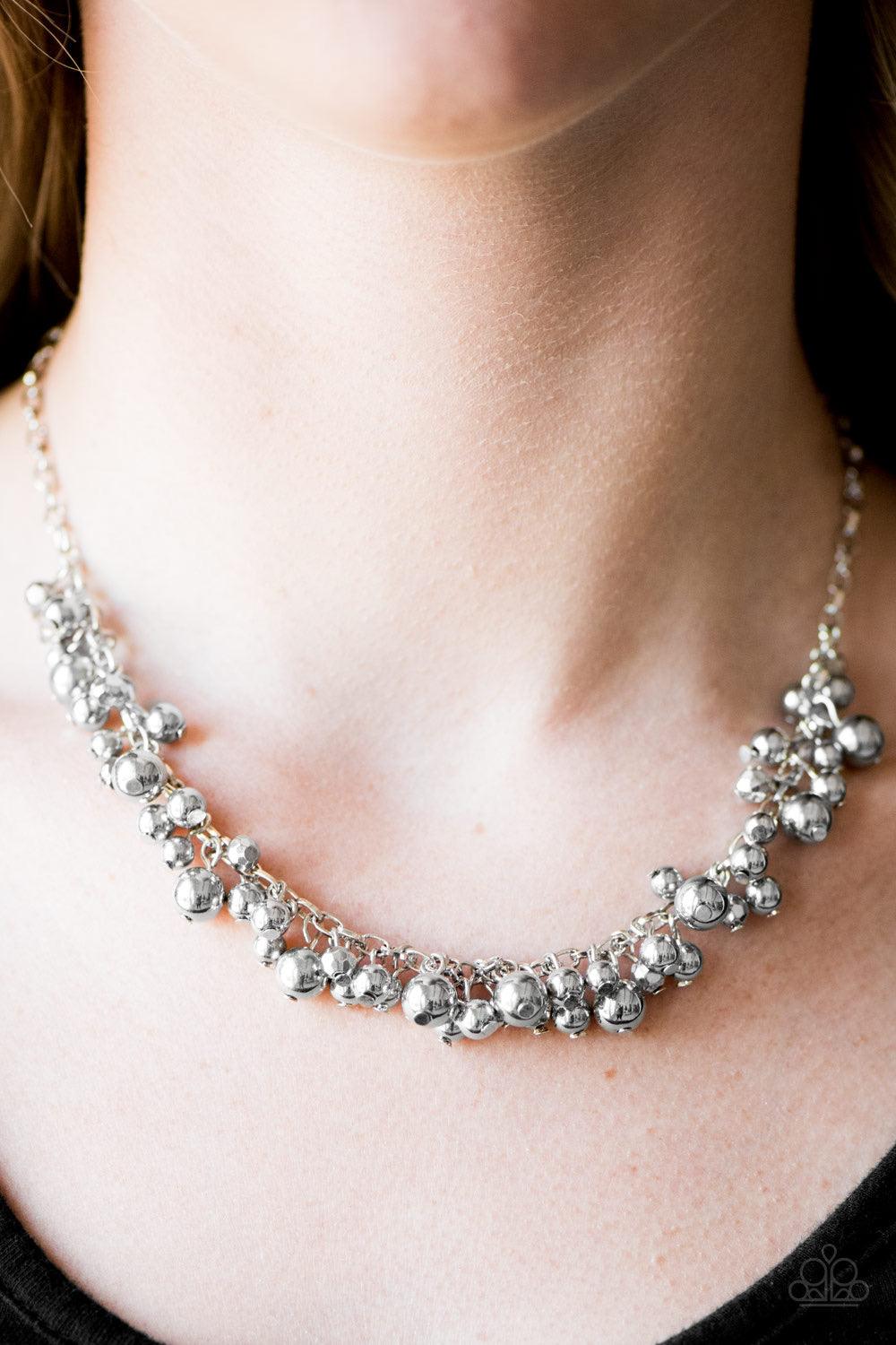 Paparazzi Accessories Belle of the Ball - Silver Varying in size and shimmer, classic and faceted silver beads trickle from the bottom of a shimmery silver chain, creating a bold fringe below the collar. Features an adjustable clasp closure. Sold as one i