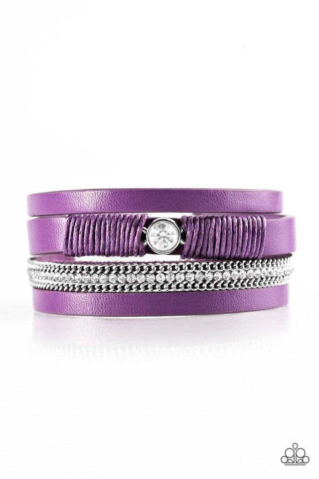 Paparazzi Accessories Catwalk Craze - Purple Vivacious purple leather strands layer across the wrist. Infused with silver chain and white rhinestone accents, purple cording knots around a leather strand, securing a solitaire white rhinestone in place for