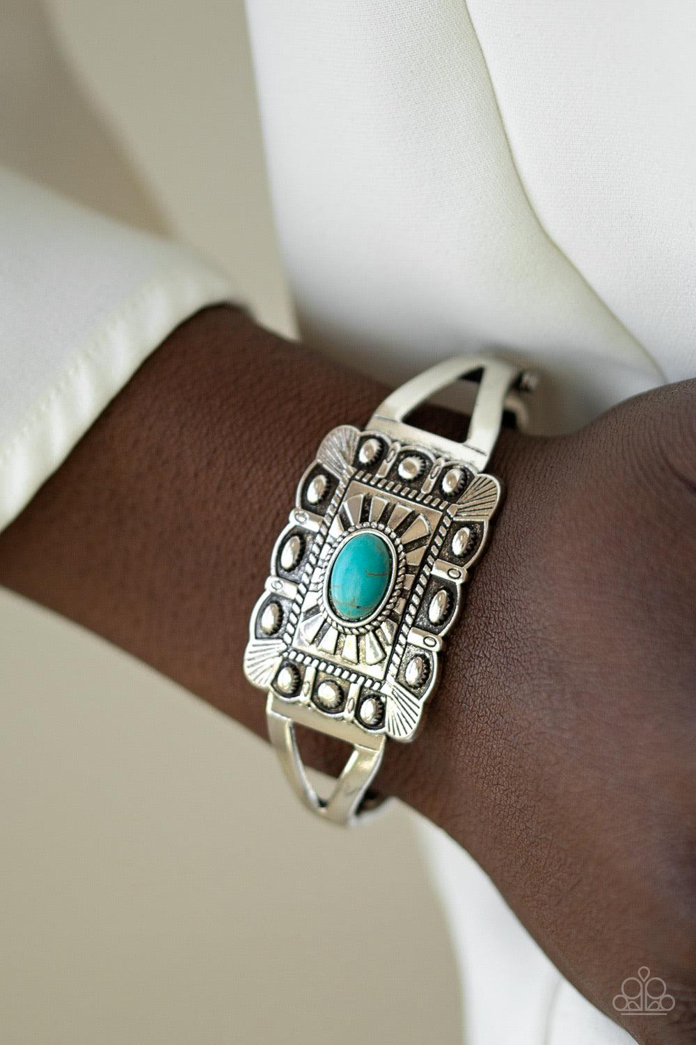 Paparazzi Accessories BIG House On The Prairie - Blue Embossed in sunburst patterns, a rectangular silver frame sits atop a bangle-like cuff for a seasonal flair. A refreshing turquoise stone is pressed into the center for a colorful finish. Features a hi