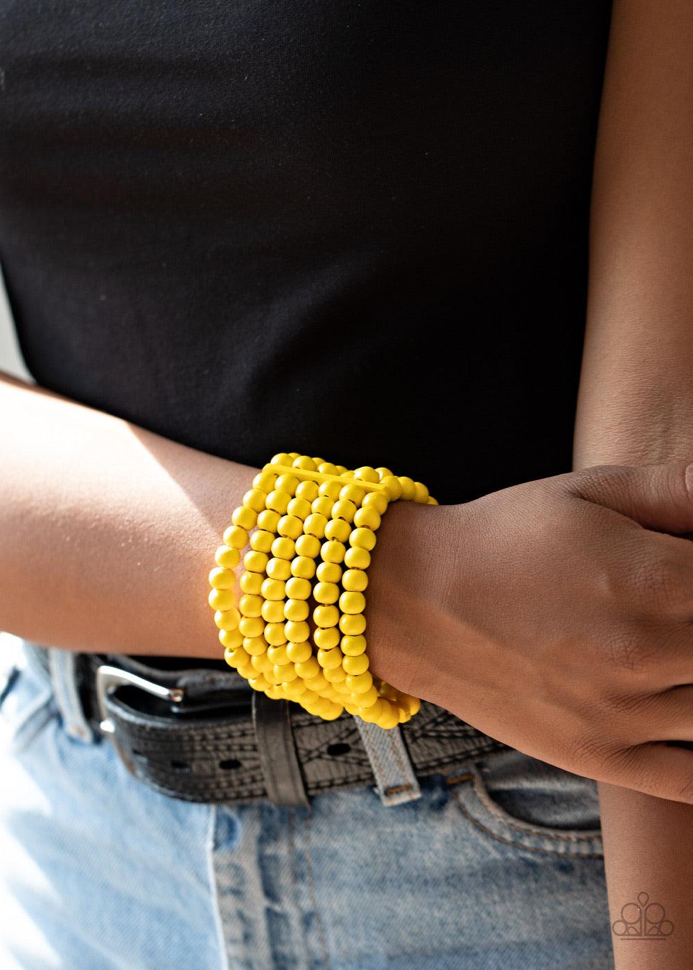 Paparazzi Accessories Diving in Maldives - Yellow Held in place with rectangular wooden fittings, a collection of sunny yellow wooden beads are threaded along stretchy bands around the wrist, creating colorful layers. Sold as one individual bracelet. Jewe