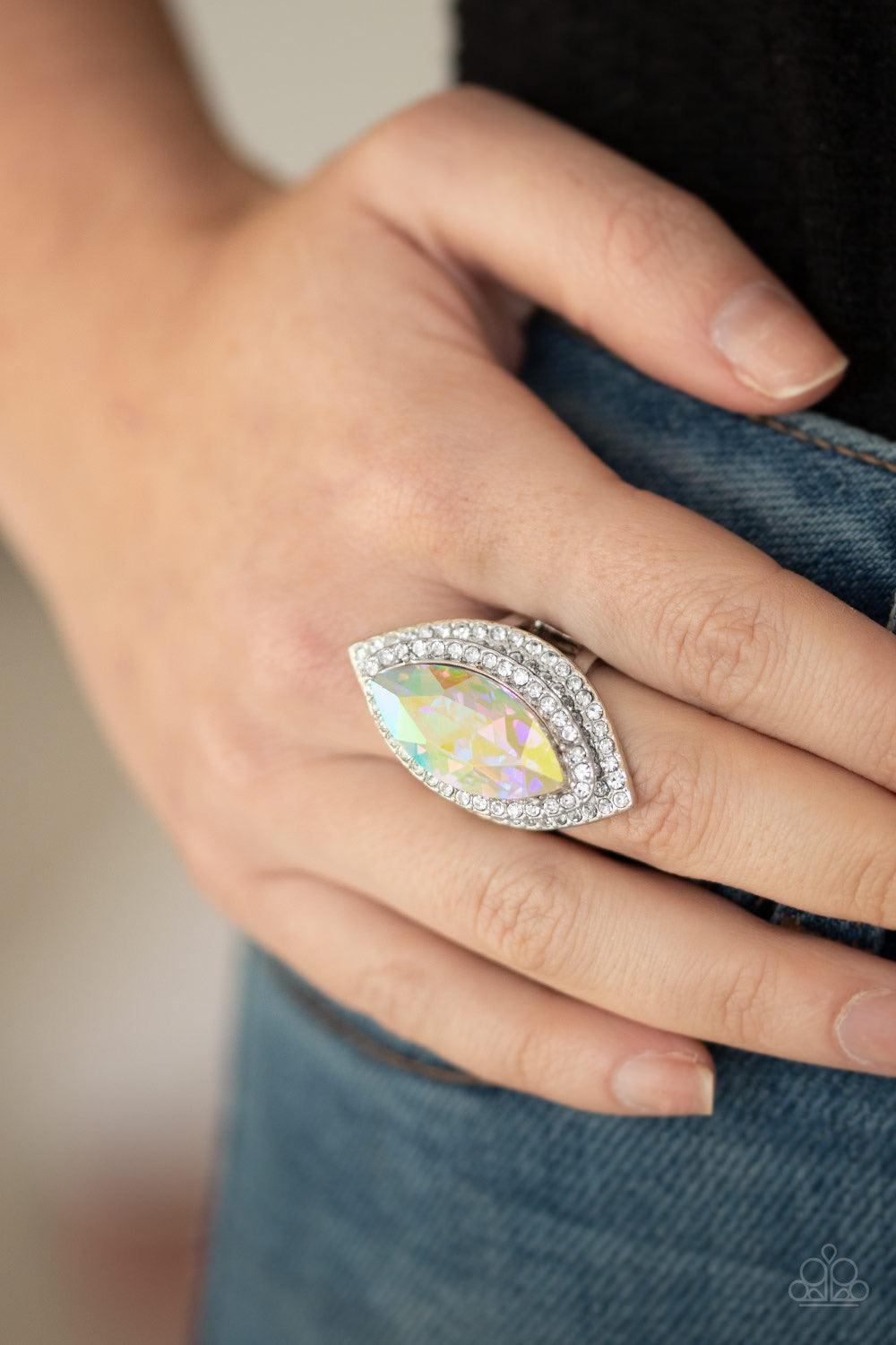 Paparazzi Accessories Jaw-Dropping Dazzle - Multi Featuring an oil spill finish, a dramatic iridescent gem is pressed into the center of stacking silver frames encrusted in row after row of glassy white rhinestones for a blinding look. Features a stretchy