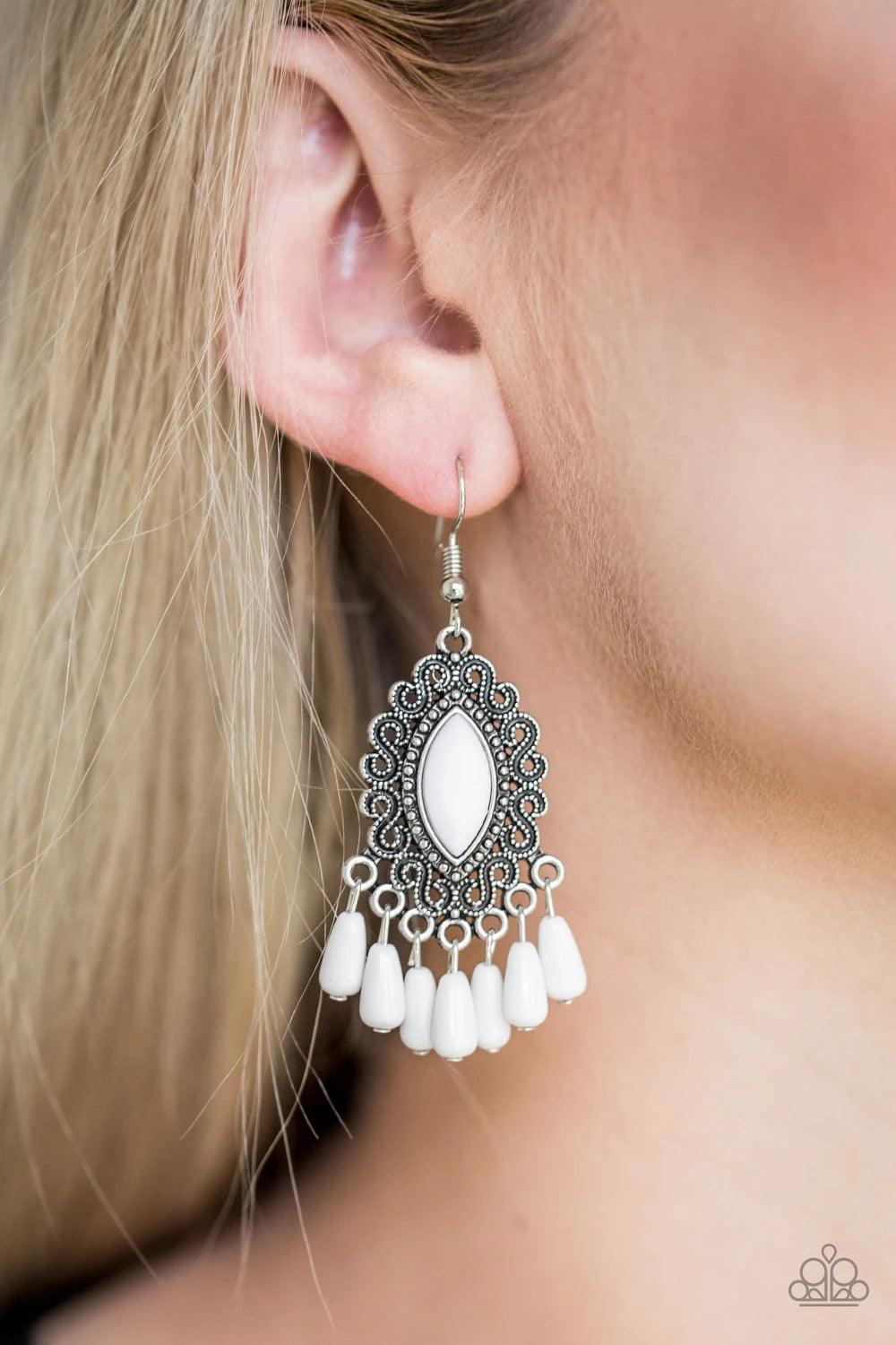 Paparazzi Accessories Private Villa - White A faceted white bead is pressed into the center of a studded silver frame radiating with antiqued filigree. Matching white beads swing from the bottom of the frame, creating a whimsical fringe. Earring attaches