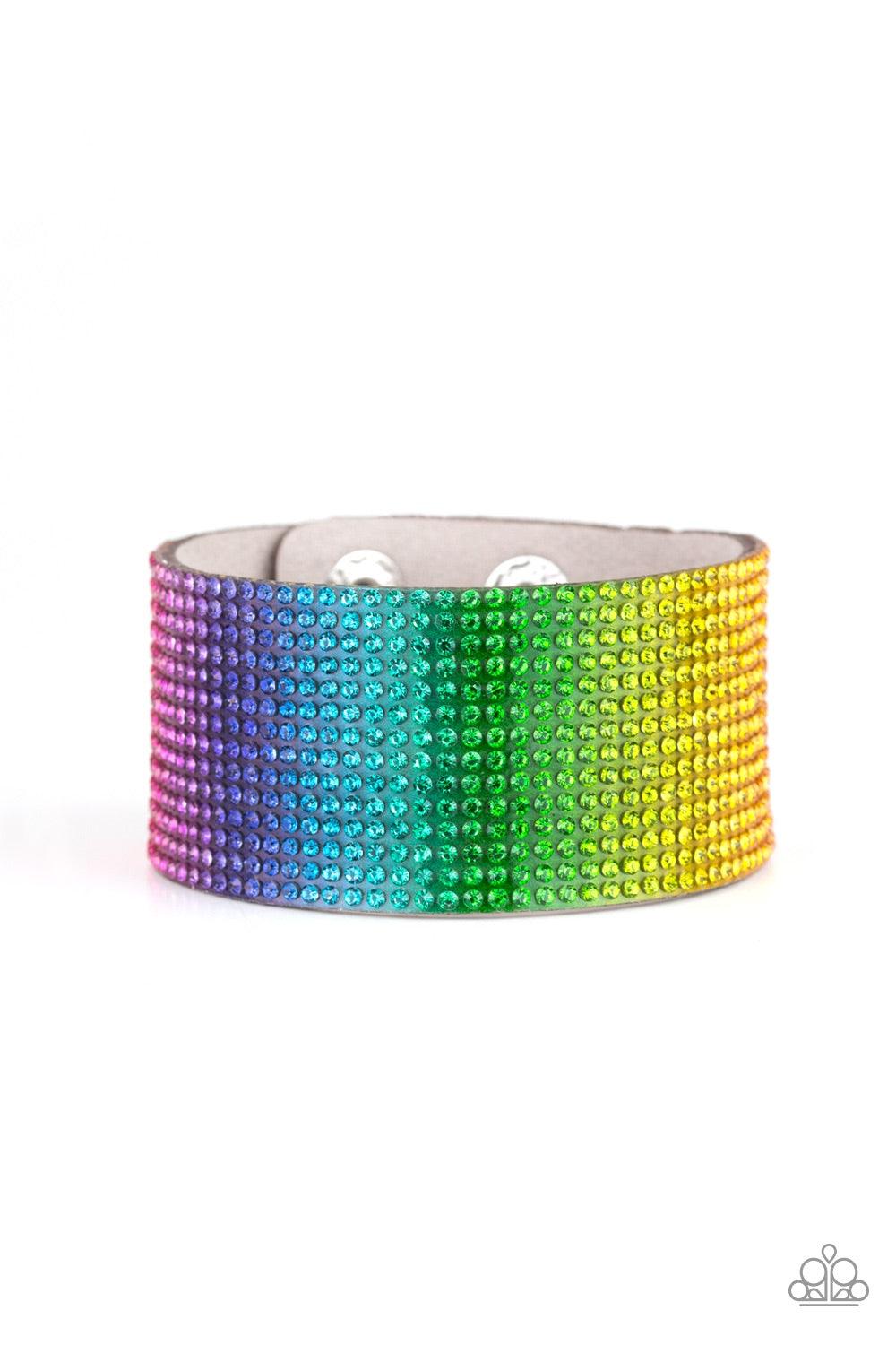 Paparazzi Accessories Fade Out - Multi Row after row of glassy rhinestones gradually fade from pink, purple, blue, green, and yellow across the front of a thick gray suede band, creating a trendy rainbow ombre. Features an adjustable snap closure. Jewelry