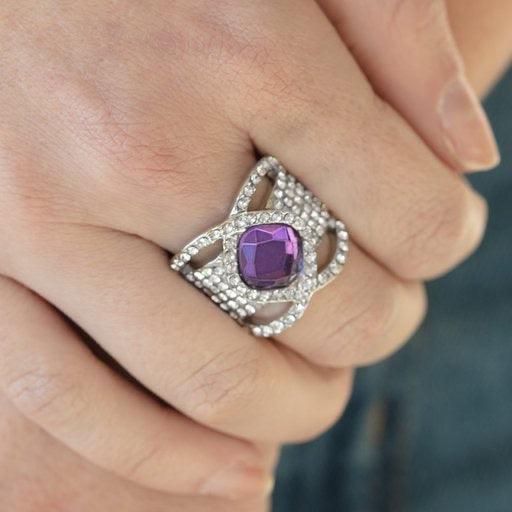 Paparazzi Accessories Triple Crown Twinkle ~Purple Featuring a regal cut, a dramatic purple rhinestone is nestled between interweaving white rhinestone encrusted bars atop a thick silver band stacked in row after row of white rhinestones for a statement-m