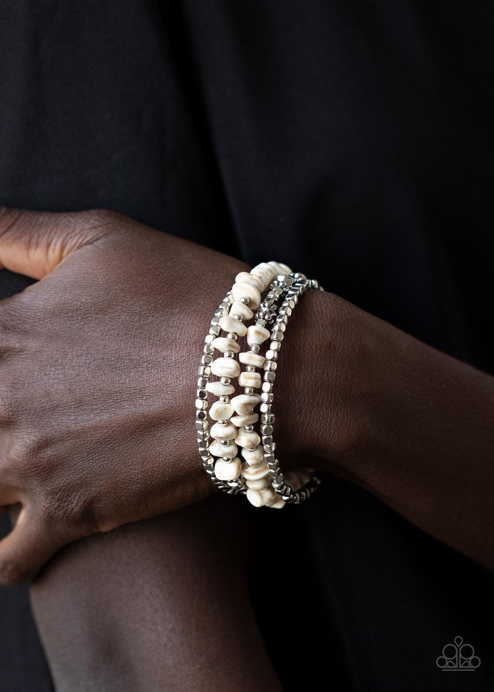 Paparazzi Accessories Rockin Renegade - White An earthy collision of white stone beads, silver cubes, and decorative silver accents are threaded along a silver wire that coils around the wrist, creating a whimsical infinity wrap bracelet. Sold as one indi