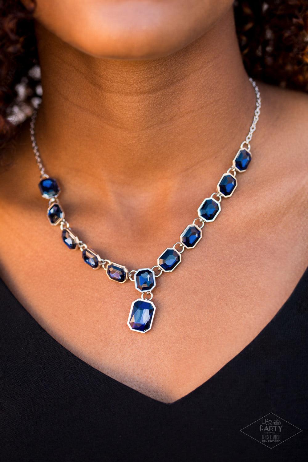 Paparazzi Accessories The Right To Remain Sparkly - Blue Featuring regal emerald style cuts, glittery blue gems link below the collar in an undeniably sparkly fashion. A slightly larger blue gem swings from the center, creating an eye-catching pendant. Fe