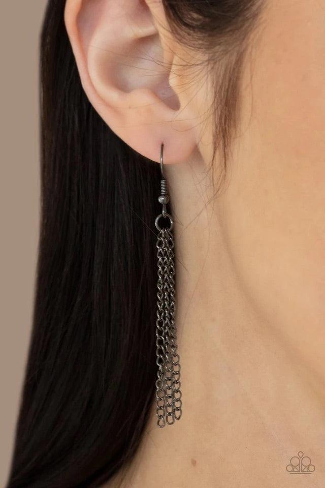 Paparazzi Accessories Renegade Ripples ~Black An asymmetrical collection of plain and hammered gunmetal ovals alternate at the bottom of a lengthened gunmetal chain, creating a dramatically stacked pendant. Features an adjustable clasp closure. Earrings