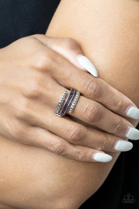 Paparazzi Accessories More To Go Around - Purple Two studded silver bars flank a dainty row of emerald cut purple rhinestones, creating the illusion of a stack of wraparound bands that make a lasting impression. Features a dainty stretchy band for a flexi