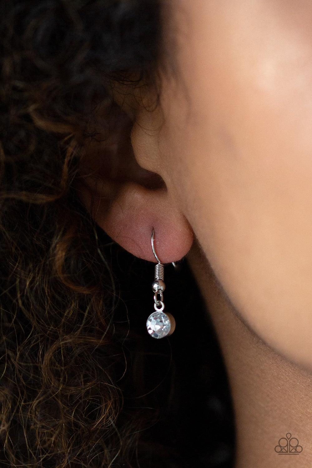 Paparazzi Accessories Stellar Sophistication - Pink A white rhinestone encrusted frame and smooth silver frame overlap at the top of a faceted pink teardrop gem, creating a dramatic pendant. The refined pendant swings from the bottom of a rounded snake ch