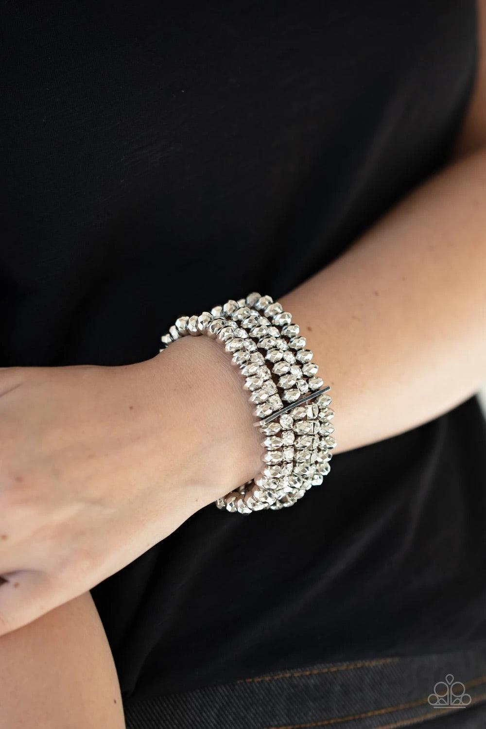 Paparazzi Accessories Best of Luxe - White Held together with a sleek silver fitting, edgy rows of faceted silver beads and glittery white rhinestones are threaded along stretchy bands around the wrist, creating glamorous layers. Sold as one individual br