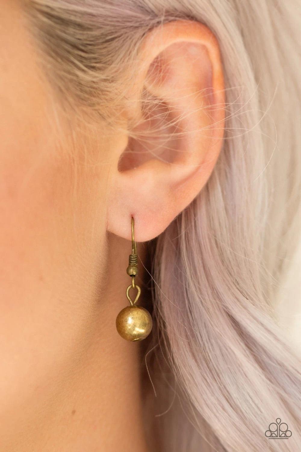 Paparazzi Accessories Power To The People - Brass Varying in size, glistening gold and antiqued brass beads drape below the collar in a dramatically asymmetrical fashion. Features an adjustable clasp closure. Sold as one individual necklace. Includes one