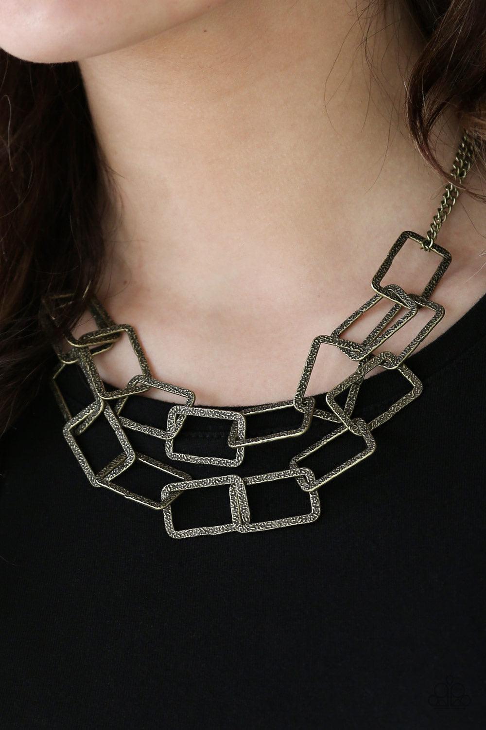 Paparazzi Accessories Seattle Scene - Brass Delicately hammered in light-catching shimmer, rows of glistening rectangular frames link below the collar for a bold industrial style. Features an adjustable clasp closure. Sold as one individual necklace. Incl