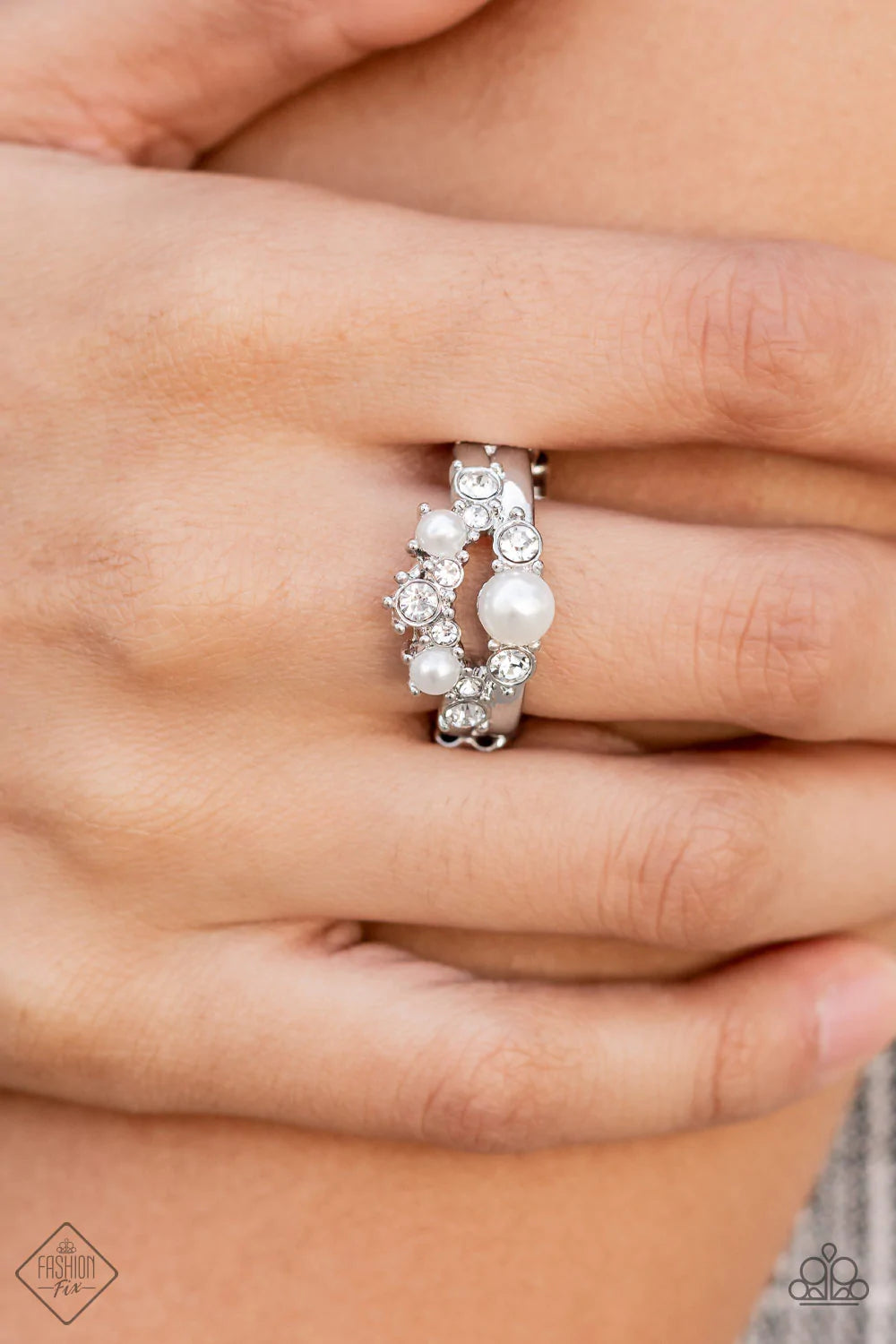 Paparazzi Accessories A-List Ambience - White Featuring pronged silver fittings, a bubbly collection of white pearls and glassy white rhinestones coalesce into two effervescent bands across the finger. Features a dainty stretchy band for a flexible fit. S