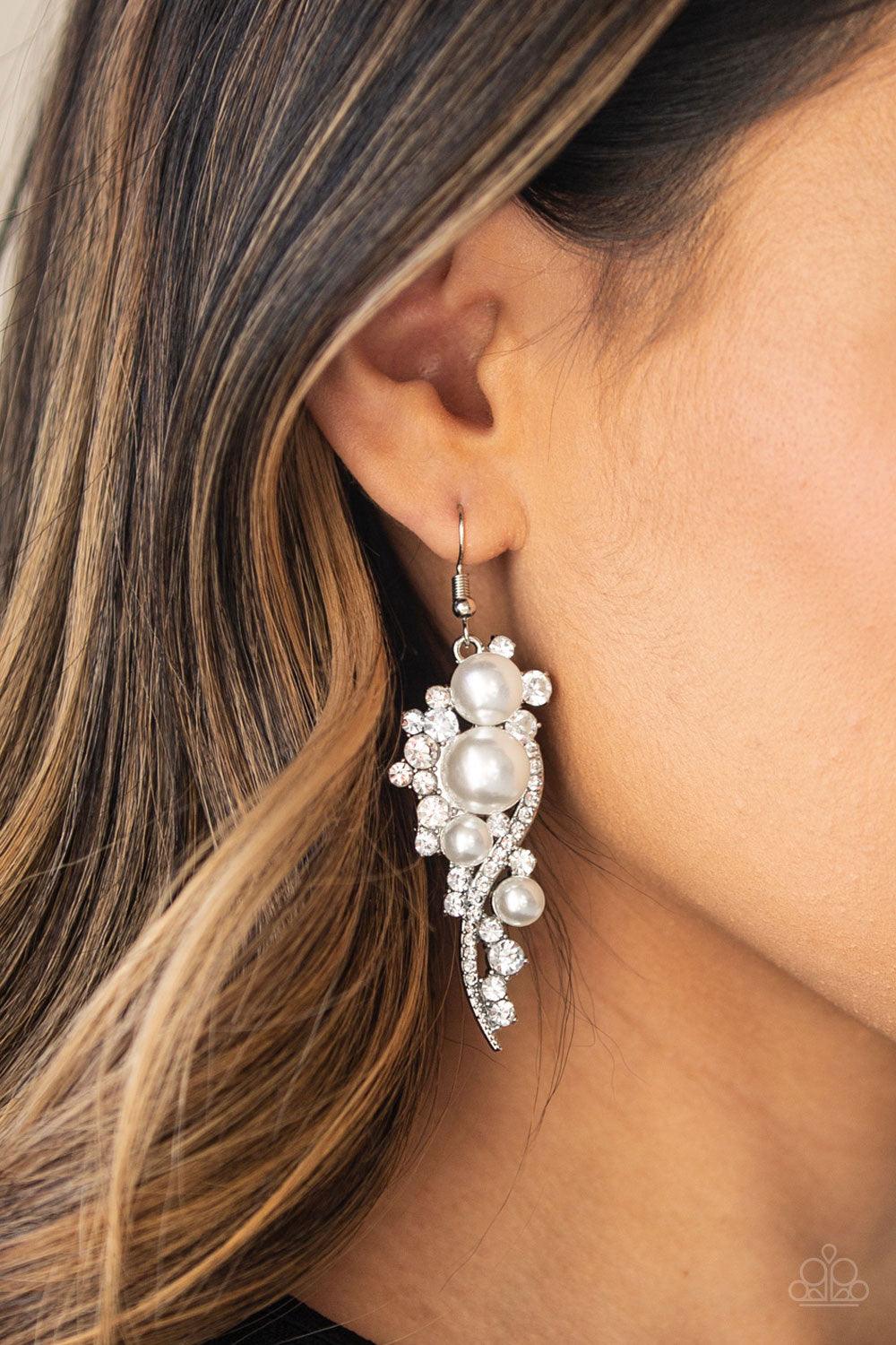 Paparazzi Accessories High-End Elegance - White Bubbly white pearls dot a glistening silver frame interwoven with ribbons of glittery white rhinestones, creating an elegant lure. Earring attaches to a standard fishhook fitting. Jewelry