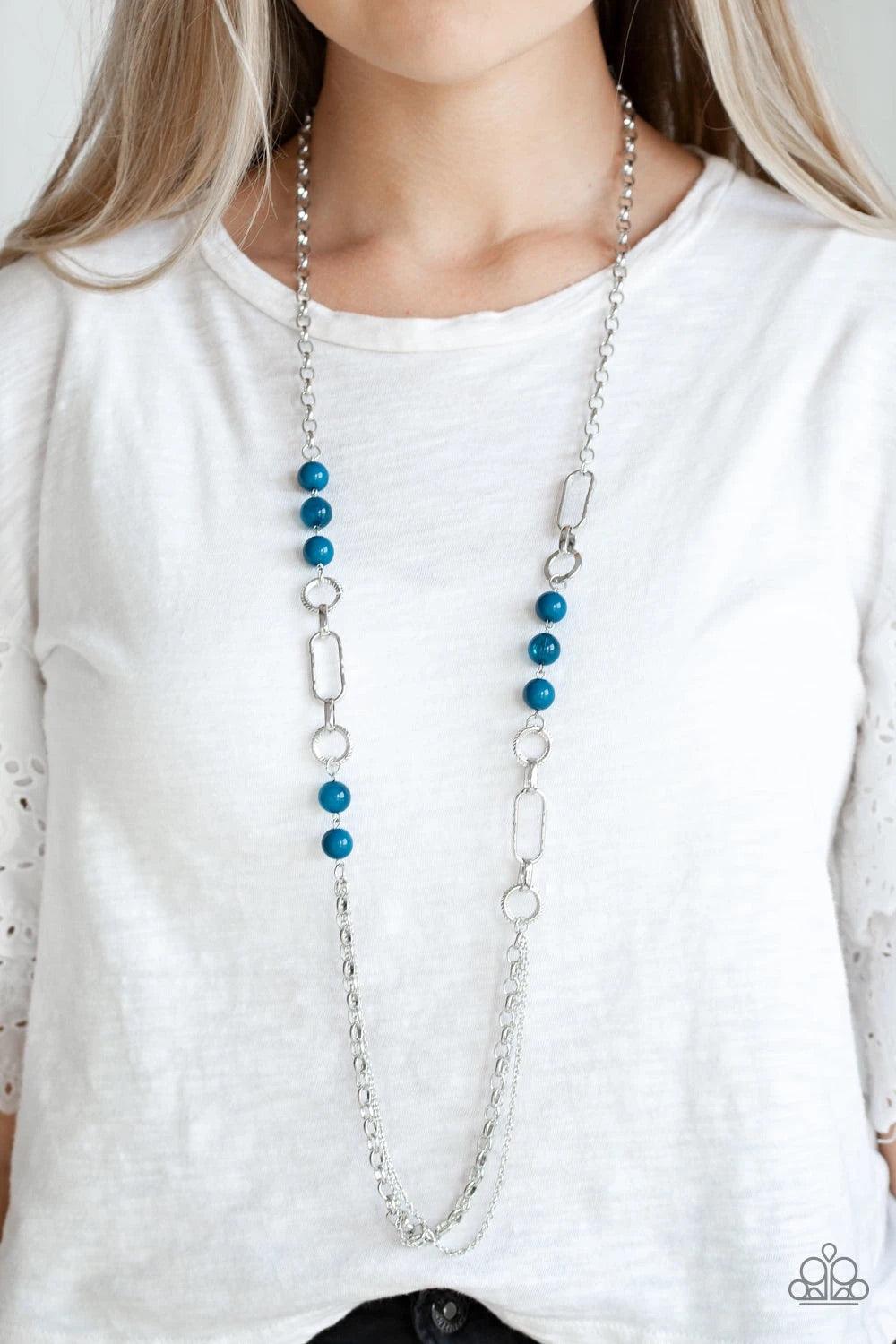 Paparazzi Accessories Cache Me Out - Blue A collection of glassy and polished blue beads give way to layers of mismatched silver chain for a whimsical look. Features an adjustable clasp closure. Sold as one individual necklace. Includes one pair of matchi