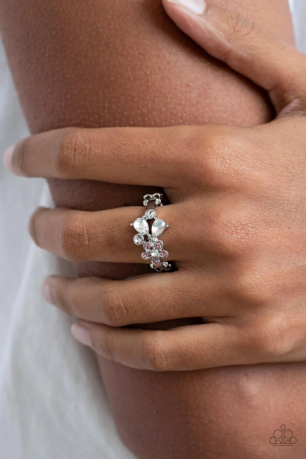 Paparazzi Accessories Enchanting Efflorescence - Pink A pink rhinestone dotted floral frame joins round and teardrop white rhinestones atop a dainty silver band, blooming into an enchanting centerpiece across the finger. Features a dainty stretchy band fo