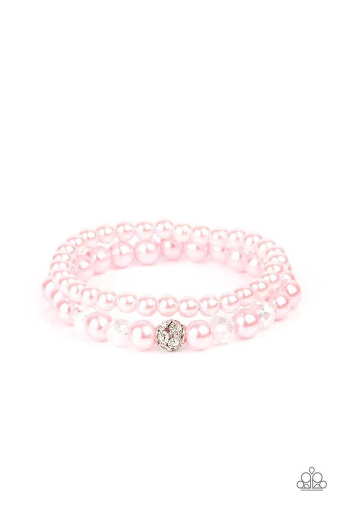 Paparazzi Accessories Cotton Candy Dreams - Pink A collection of dainty pink pearls and glassy crystal-like beads are threaded along two stretchy bands around the wrist, creating timeless layers. A white rhinestone encrusted silver bead adorns the center