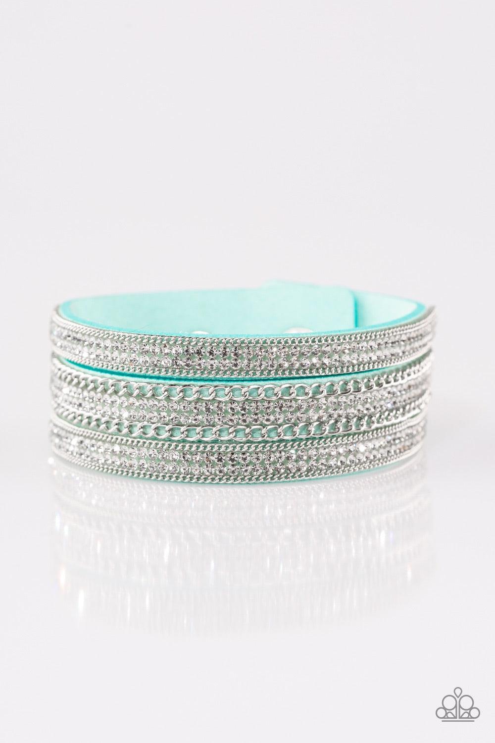 Paparazzi Accessories Dangerously Drama Queen - Blue Rows of shimmery silver chains and glassy white rhinestones are encrusted along a blue suede band. The glittery band has been spliced into three strands, creating row after row of blinding shimmer for a