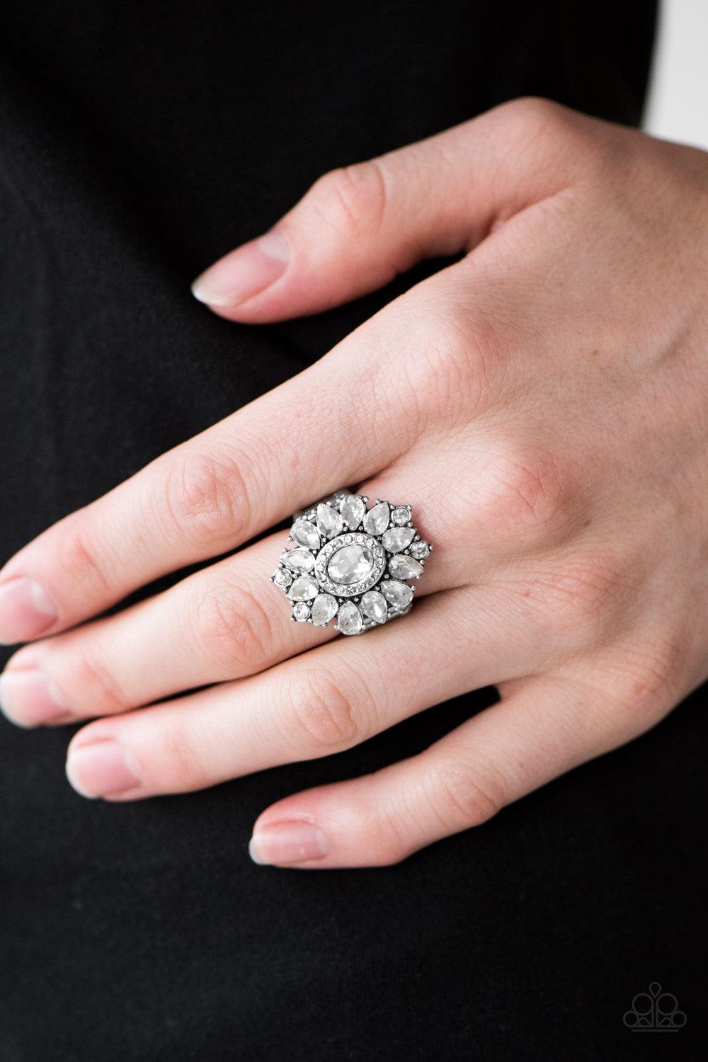 Paparazzi Accessories Garden Gala - White Featuring elegant teardrop cuts, glittery white rhinestones spin around a glassy gem, creating a regal floral centerpiece. Features a stretchy band for a flexible fit. Jewelry