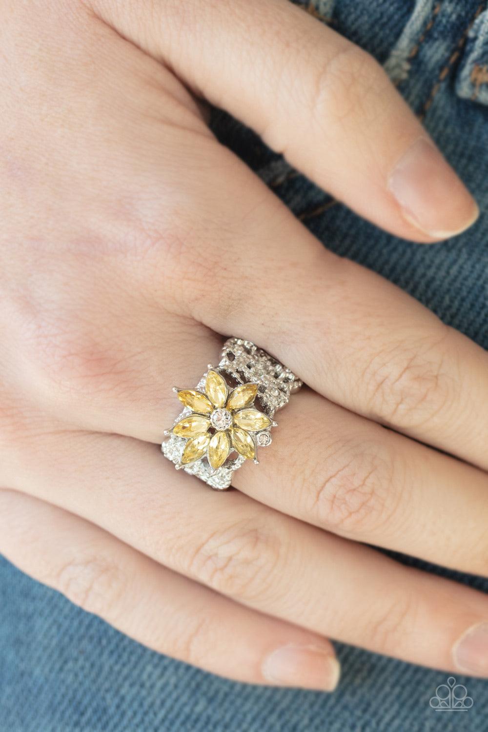 Paparazzi Accessories Brilliantly Blooming - Yellow Featuring yellow marquise rhinestone petals, a glittery flower blooms atop an interweaving silver band dotted with dainty white rhinestones and studded texture. Features a stretchy band for a flexible fi