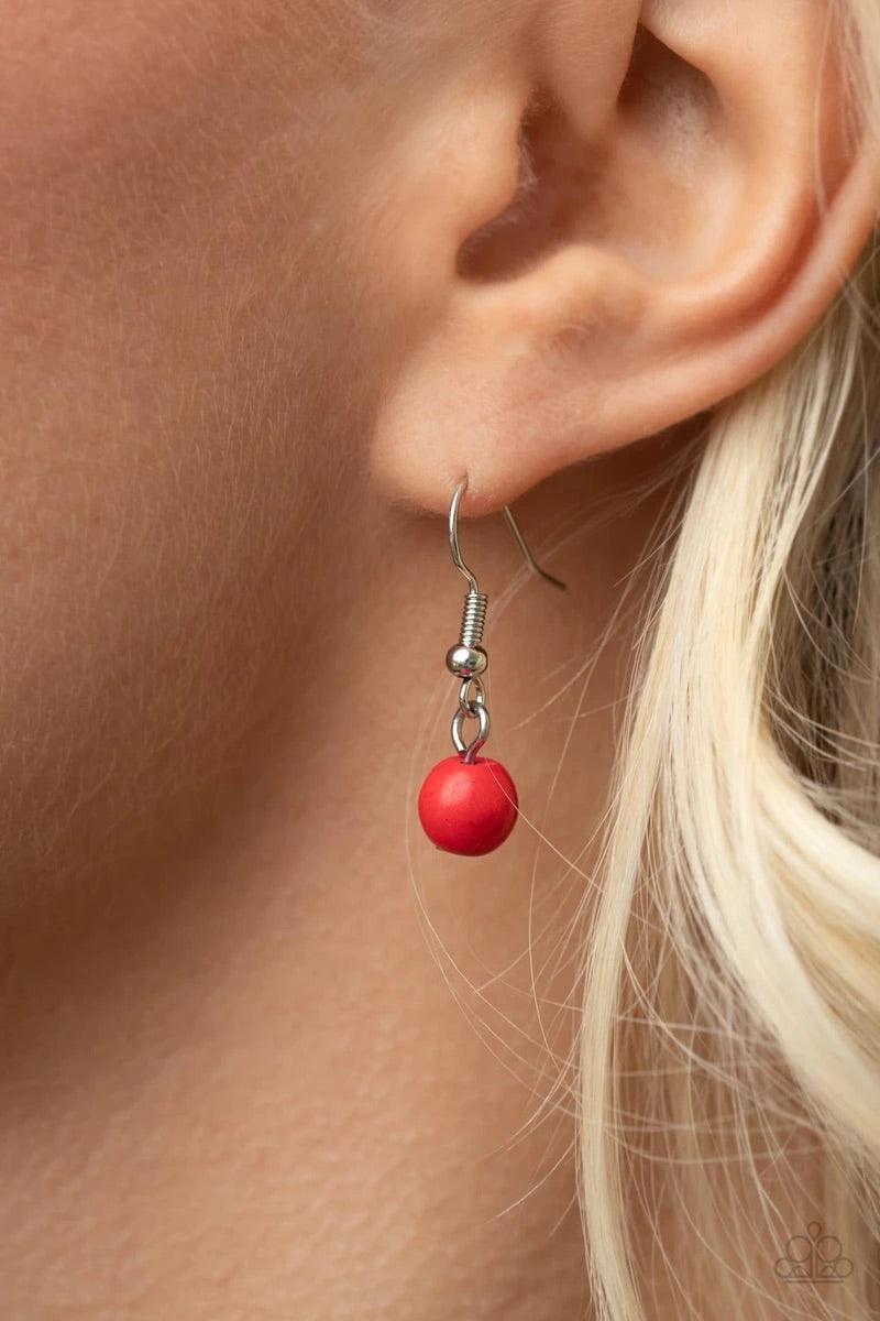 Paparazzi Accessories Geographically Gorgeous - Red A large red stone encased in a studded silver frame swings dramatically from a heavy silver chain with oversized links. A collection of red stones wraps around the bottom of the large pendant, with an el