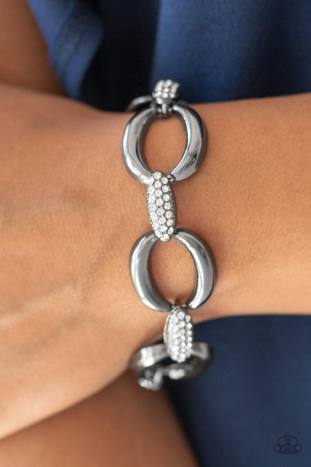 Paparazzi Accessories Don’t Forget Who’s Boss - Black Bold gunmetal links join with white rhinestone encrusted frames around the wrist for a fierce look. Features an adjustable clasp closure. Sold as one individual bracelet. Jewelry