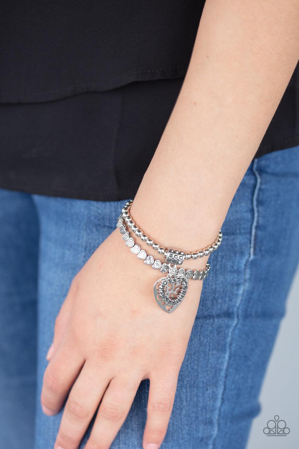 Paparazzi Accessories Think With Your Heart - Silver Brushed in an antiqued finish, classic silver beads and dainty silver heart beads are threaded along stretchy bands around the wrist, creating an adorable duo. Infused with a hematite rhinestone encrust