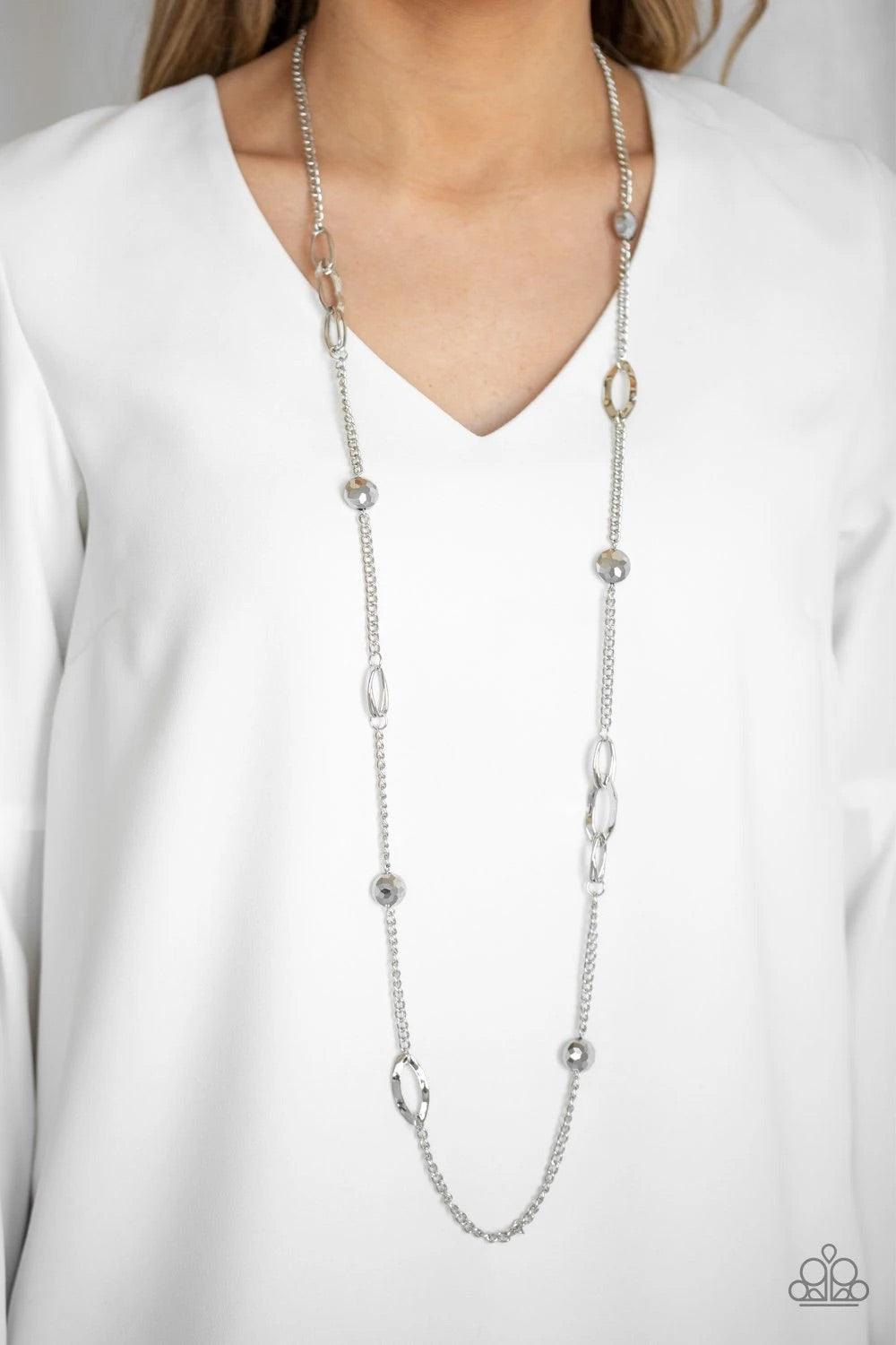 Paparazzi Accessories Duchess Dazzle - Silver A collection of hematite rhinestone gems and abstract silver rings trickle along a classic silver chain across the chest for a refined flair. Features an adjustable clasp closure. Sold as one individual neckla