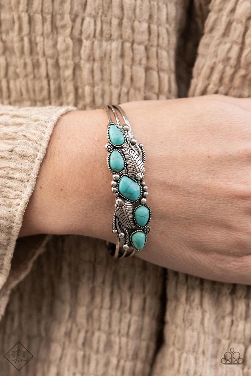 Paparazzi Accessories Cottage Living - Blue A collection of asymmetrical turquoise stones adorns the front of a studded silver frame embossed in floral and feathery accents atop a layered silver cuff. Sold as one individual bracelet. Jewelry
